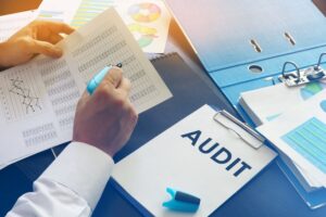 Document with title Audit on an office table.